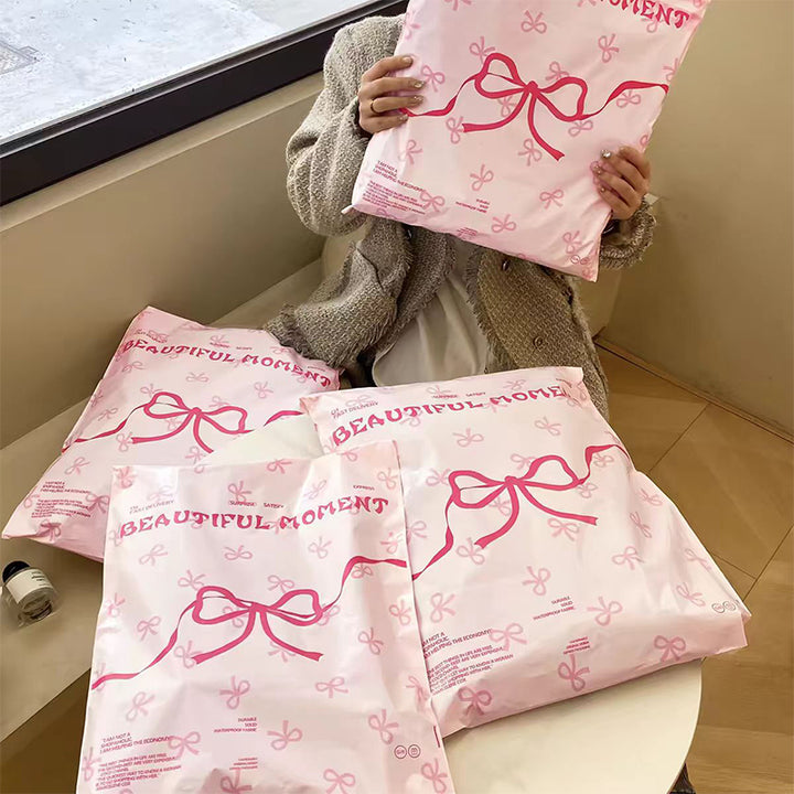 Pink bow-tie express delivery bag, clothing packaging bag, express delivery packing bag, thickened colorful express delivery bag wholesale.