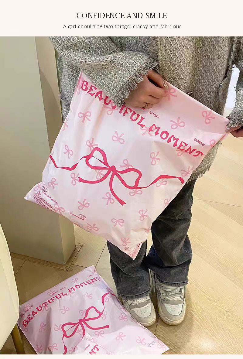 Pink bow-tie express delivery bag, clothing packaging bag, express delivery packing bag, thickened colorful express delivery bag wholesale.